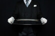 Portrait of Elegant Butler in Dark Suit and White Gloves Holding Large Silver Serving Tray. Service Industry and Professional Hospitality.