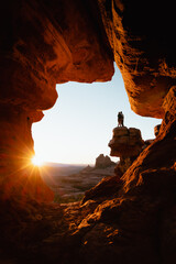 Wall Mural - Young couple hugs at popular viewpoint rock formation in Sedona Arizona at golden orange sunset.