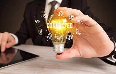 Businessman holding a light bulb, social media concept