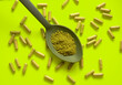 kratom pills composition on yellow background with kratom filled spoon