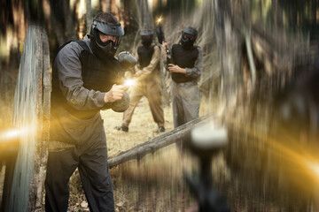 Poster - Teams of friends facing on battlefield in outdoor paintball arena