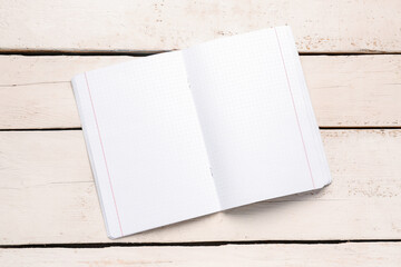 Blank copybook pages on white wooden background