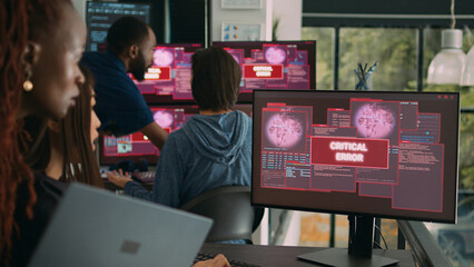 Team of system engineers having web server hacked, reading critical error on multiple monitors in office. Diverse software developers trying to solve hacking problem, firewall security.