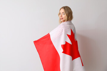 Sticker - Young woman with flag of Canada on light background