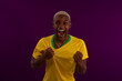 © Rickphotoes - Black-skinned Brazilian man with Brazilian soccer team shirt in studio photo