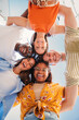 © Jose Calsina - Vertical low view angle of a group of multiracial teenagers smiling and looking at camera together. Portrait of five young students smiling and laughing. Cheerful people having fun and embracing. High