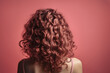 View from the back of the girl with beautiful curly hair over pink background. Hair care and styling, generative ai