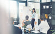 © Thurstan H/peopleimages.com - Presentation, business woman and leader talking to a team in an office for brainstorming or workshop. Female coach writing on whiteboard with people listening for training, strategy or information