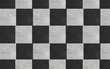 Seamless black and white checkboard or chess board marble tile background grainy texture. Kitchen or bathroom natural stone wall, floor or countertop. A high resolution tileable luxury pattern.