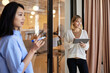 © Cavan Images - Smiling businesswoman holding tablet PC with female colleague at cafe