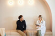 © Cavan Images - Male patient discussing with female doctor sitting on couch in clinic