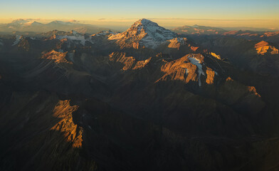  Aconcagua Peak from Andes Mountains at sunset. Aerial photo with the amazing sunset landscape over the tallest peaks in South America, part of Andres Mountains.