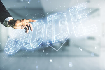 Wall Mural - man hand presses on code word hologram on blurred office background, international software developm