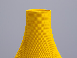 Geometric 3D printed vase made from yellow 3D printing filament