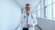 © Jacob Lund - Portrait of a mature medical doctor standing in a hospital with a lab coat and a stethoscope