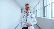 Portrait Of A Mature Medical Doctor Standing In A Hospital With A Lab Coat And A Stethoscope