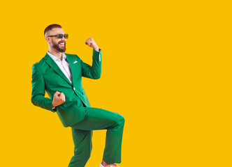 Wall Mural - yes, awesome, cool. side view of happy smiling overjoyed handsome man wearing trendy green suit and 