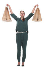 Wall Mural - Smiling woman raising her shopping bags against a white background