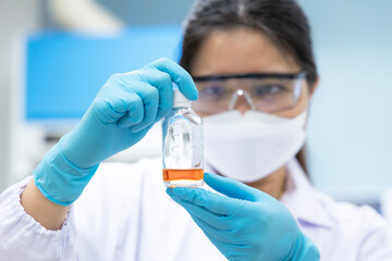 professional scientist holding solution bottle for test coliform or bacteria in water and ice at che