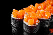 sushi roll maki New York with cubes of salmon on a black mirror background