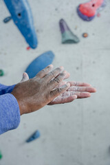 Wall Mural - Close-up view of woman applying climbing chalk