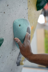 Wall Mural - Close-up of woman hand gripping climbing hold