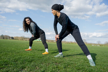 Female soccer players warming up