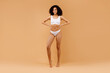 © Prostock-studio - Full body length shot of slim black woman posing in white underwear, showing perfect figure, copy space