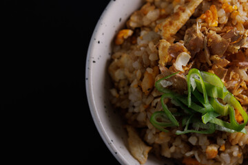 Wall Mural - Japanese fried rice yakimeshi isolated in black background