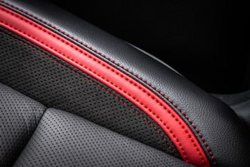 Wall Mural - close-up black and red  perforated leather car seat. Skin texture