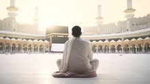 A Muslim Man Praying Facing The Kaaba In Mecca, A View Of The Kaaba In Mecca And The Crowds Of Muslims, Generative AI