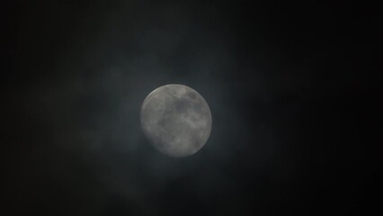 close-up full moon with storm clouds in the night
