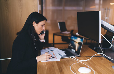 Sticker - Young woman working with documents while using smartphone