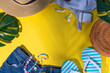 © ricka_kinamoto - Summer girl fashion flat lay on high-colored yellow background. Holiday party, vacation, travel comfortable casual woman outfit - t-shirt, shorts, flip flops, straw hat, sunglasses, with palm leaf