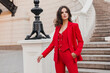 © mary_markevich - beautiful sexy rich business style woman in red suit walking in city street, spring summer fashion trend