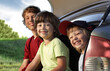 © Chepko Danil - Three cheerful child sitting in the trunk of a car on nature