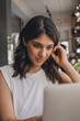 © Tatyana - Attractive positive young woman using a laptop in a cafe.Remote work,blogging,business, freelance,e-learning.