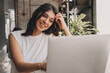 © Tatyana - Attractive positive young woman using a laptop in a cafe.Remote work,blogging,business, freelance,e-learning.Copy space for text.