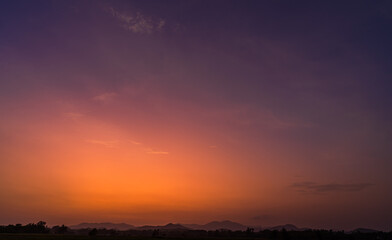 Wall Mural - dusk sky over silhouette mountain in the evening on twilight after sundown with sunset orange, red s
