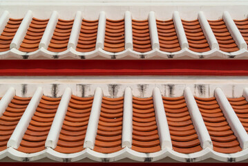 Two layer of red roof tiles on house, tile pattern