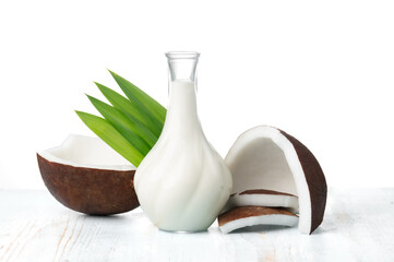 Wall Mural - coconut and coconut milk in glass jug on wooden table