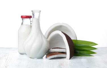 Wall Mural - coconut and coconut milk in glass jug on wooden table
