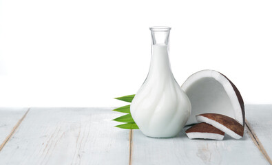 Wall Mural - coconut and coconut milk in glass jug on wooden table