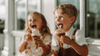 Two happy kids laughing over some ice cream.