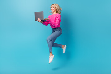 Sticker - Full body photo of optimistic lady jumping hold netbook working remote running her second part time job isolated on blue color background