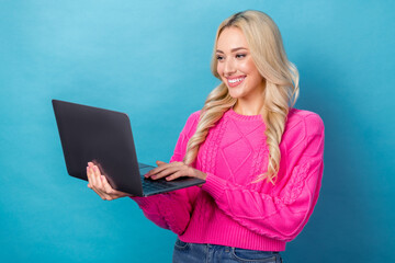 Canvas Print - Photo of cheerful optimistic girl with curly hairstyle dressed knit sweater read email look at laptop isolated on blue color background