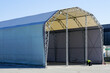 Unfinished large prefabricated arched metal frame tent hangar covered with polyvinyl chloride fabric