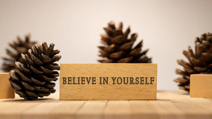 Believe in yourself written on wooden surface.