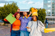 © Alberto - three teenage girls, latin and black, celebrating the end of exams as they exit the school building. end of school and vacation friendship between women