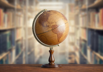 Wall Mural - Old geographical globe and old book in cabinet with bookselfs. Science, education, travel background. History and geography team. Ancience, antique globe on the background of books.